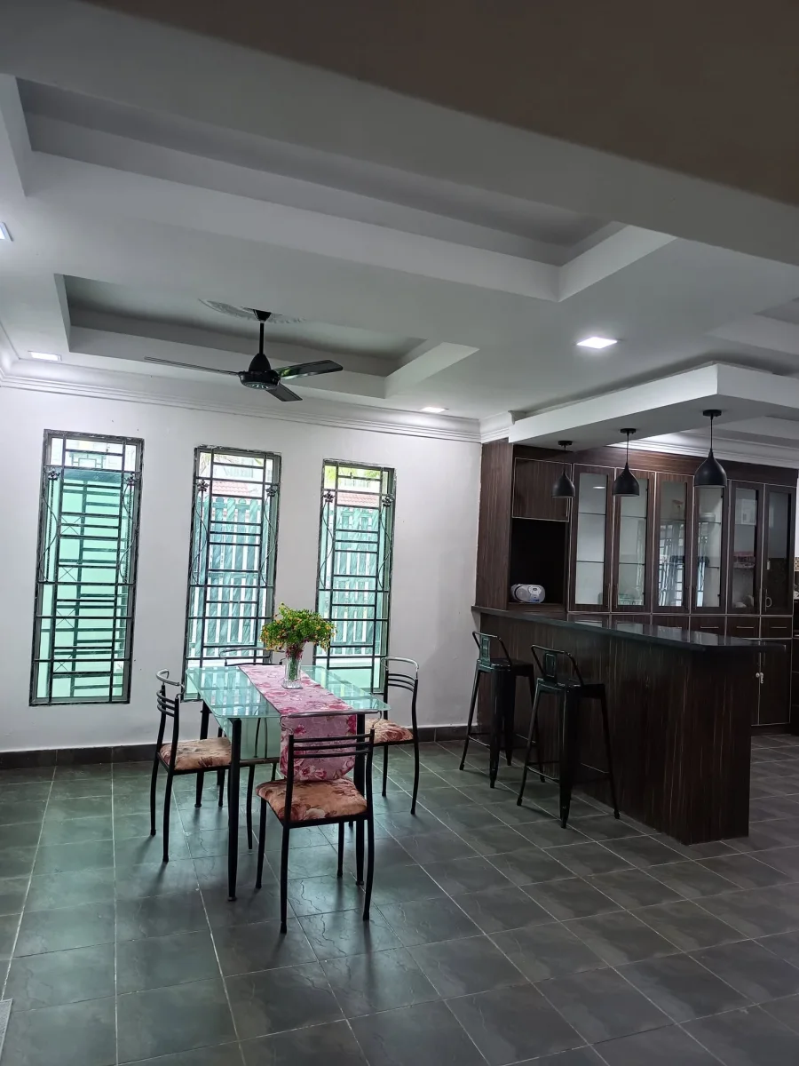 View across the dining table towards the kitchen counter at Paradise Lodge